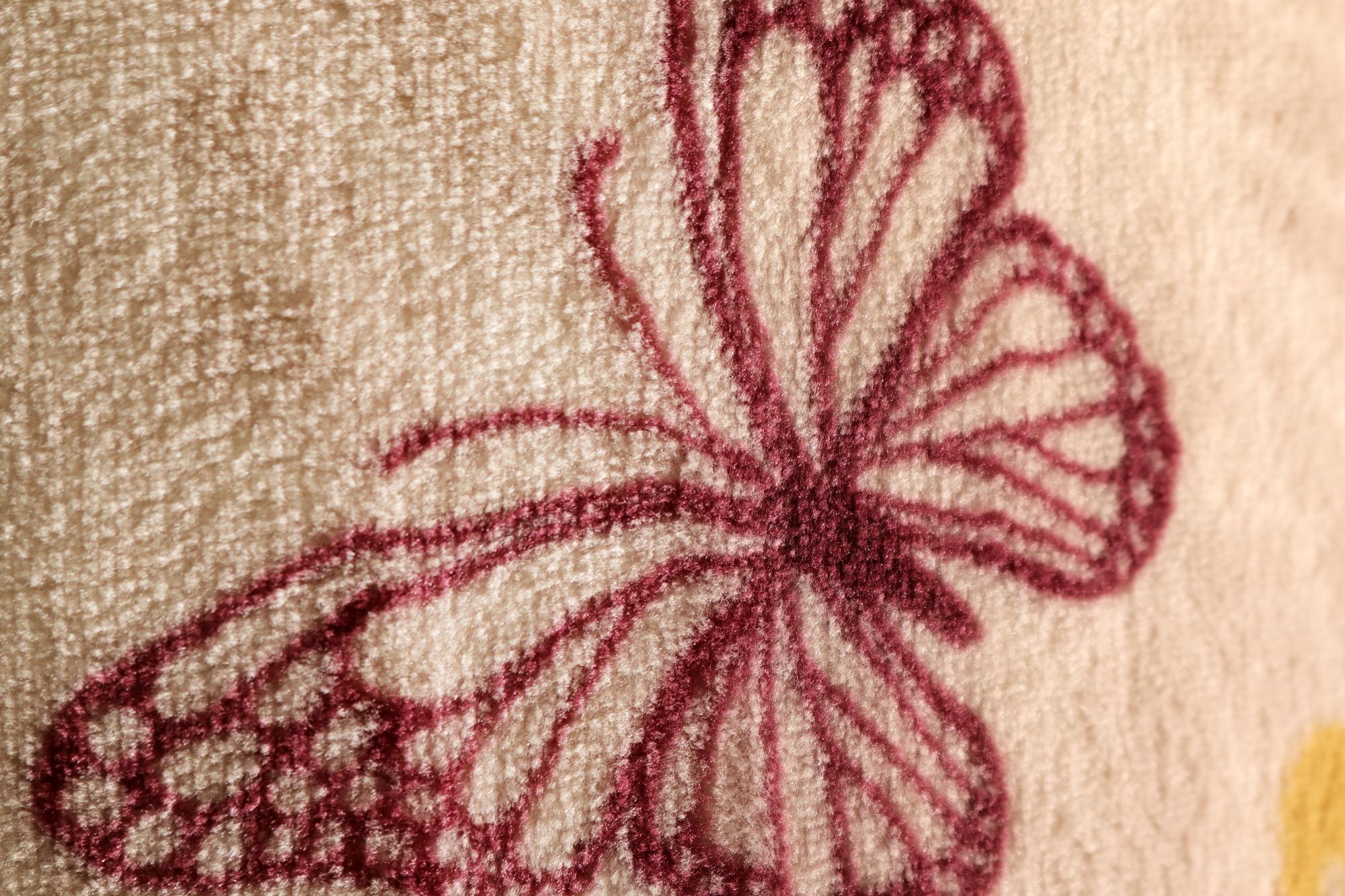 Close-up of embroidered floral patch on linen